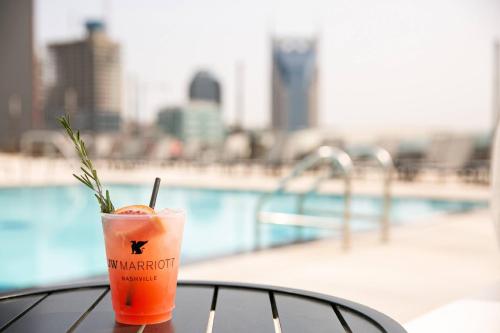 a drink sitting on a table next to a pool at JW Marriott Nashville in Nashville