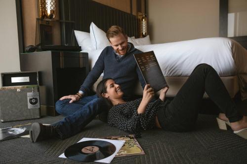 a man and woman laying on the floor reading a book at JW Marriott Nashville in Nashville
