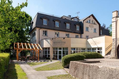 a large building with a table in front of it at Hotel Rehavital in Jablonec nad Nisou