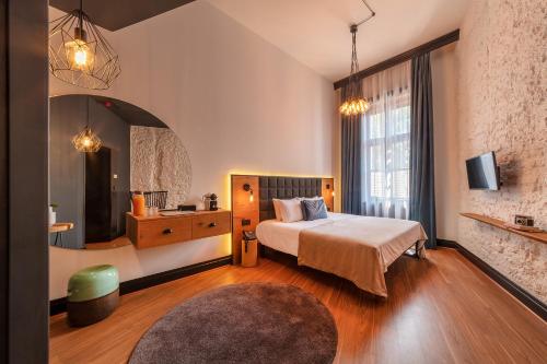 a bedroom with a bed and a large window at Hotel Rum Budapest in Budapest