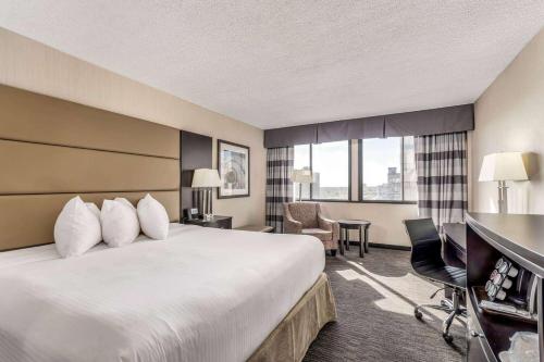 a hotel room with a bed and a desk at Ramada Plaza by Wyndham Regina Downtown in Regina