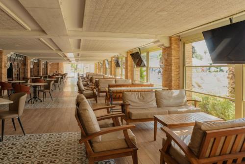 a waiting room with couches and tables and windows at Swandor Hotels & Resorts - Topkapi Palace in Lara