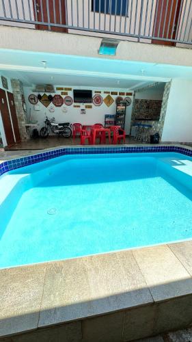 a large blue swimming pool in a building at Pousada Caminho das Cachoeiras Pirenopolis in Pirenópolis