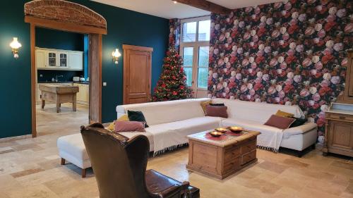una sala de estar con un árbol de Navidad y un sofá blanco en Altegaar, en Zottegem