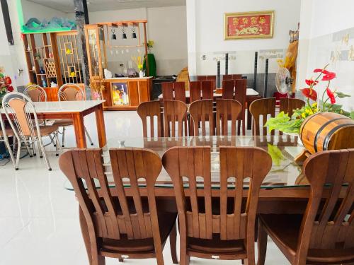 a dining room with a wooden table and chairs at Nybipu Homestay in Phan Rang