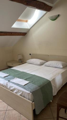 ein Schlafzimmer mit einem weißen Bett und einer grünen Decke in der Unterkunft A pochi passi dal centro in Novara