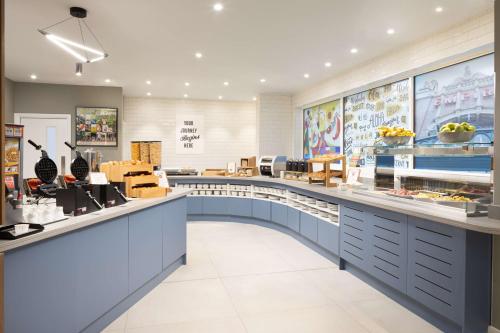 a restaurant with a food counter in a store at Hampton By Hilton London Old Street in London