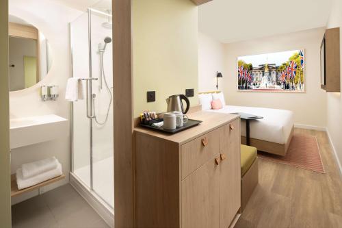a bathroom with a sink and a shower in a room at Hampton By Hilton London Old Street in London