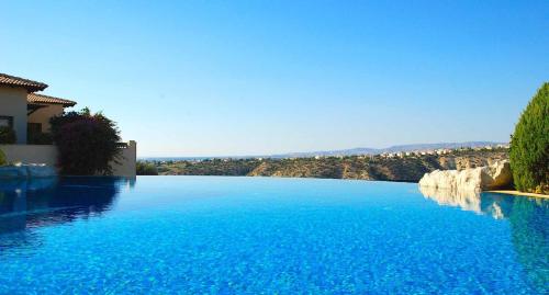 a large pool of blue water in a house at Charming Apartment PZ12 - Lefkara, Aphrodite Hills in Kouklia