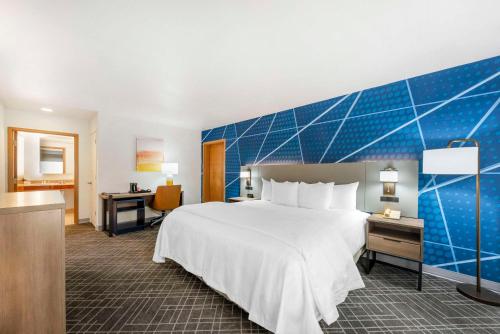 Habitación de hotel con cama y pared azul en Comfort Inn - Killeen near Fort Cavazos, en Killeen