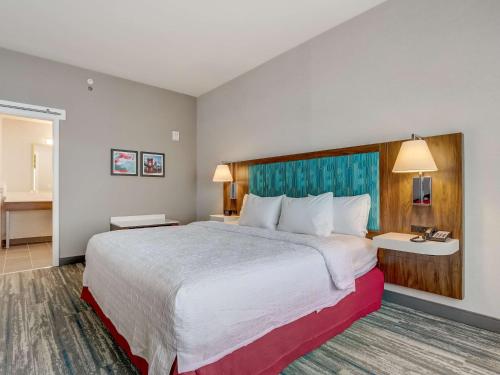 a hotel room with a large bed in a room at Hampton Inn & Suites Cincinnati Midtown Rookwood in Cincinnati