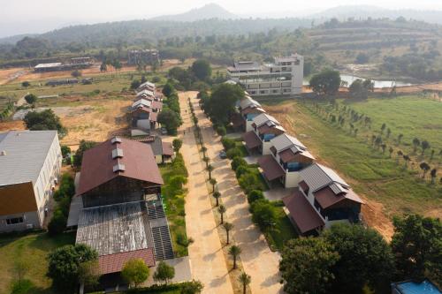 an aerial view of a village with houses and trees at Lake Valley Resort and Spa Tirupati in Tirupati