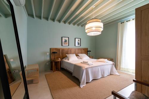 a bedroom with a bed in a room with a ceiling at Guava Azores in Ribeira das Tainhas