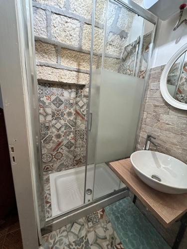 a bathroom with a shower and a sink at Antico casale Sofia in Sortino