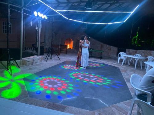 a bride and groom standing on a stage with a light painting at Finca Andalucia con Piscina en Mesitas in El Colegio
