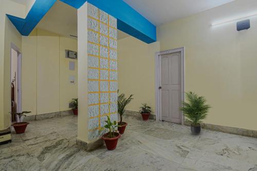 a room with potted plants and a blue ceiling at OYO Vibrant Inn in Patna