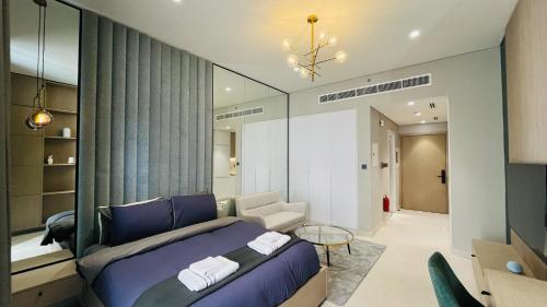 a bedroom with a bed and a living room at Modern Studio- 115 Westwood Al furjan in Dubai
