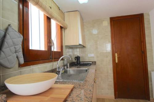 a kitchen with a sink and a large bowl on a counter at Vila Sitges, big house with pool in Sitges