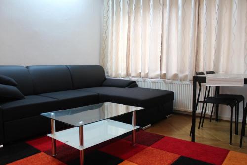 a living room with a couch and a table at Apartments Ålholmvej in Copenhagen