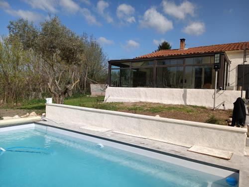 a swimming pool in front of a house at Villa les Doms in Mazan