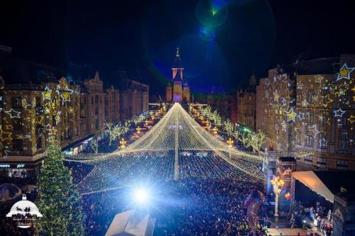 a large christmasmas tree on a city street at night at Joy City Stay Victoriei 7E-30 2 in Timişoara