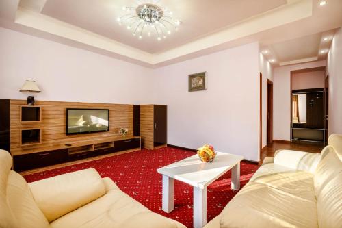 a living room with a couch and a table at Alpina Resort by Stellar Hotels, Tsaghkadzor in Tsaghkadzor