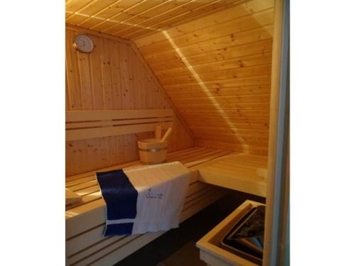 a small wooden sauna with a box in it at Holiday home Aunt Emma in Zierow