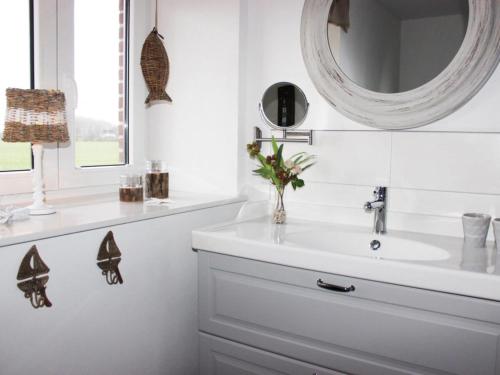 a white bathroom with a sink and a mirror at Cathedral day "Key West" in Kronsgaard