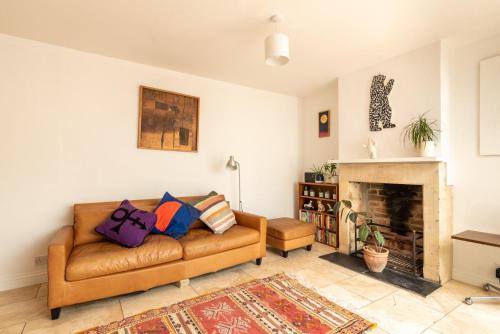 a living room with a couch and a fireplace at GuestReady - A Bohemian Home in Bath in Bath