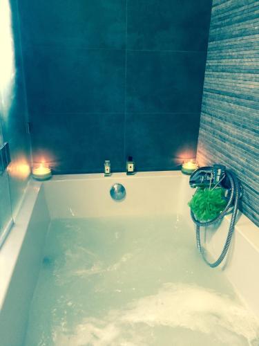 a bath tub with two lights on top of it at Cecile's Villa in Casal do Pardo