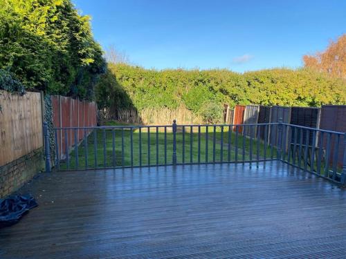 a gate on a wooden deck with a fence at 3BD Sanctuary in Beeston, Nottinghamshire in Beeston