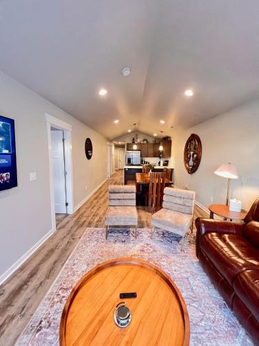 a living room with a couch and a table at Modern Style KING bed Free Wi-Fi with Garage in Spokane Valley
