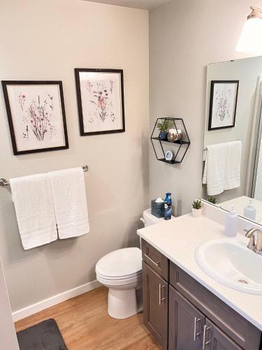 a bathroom with a toilet and a sink at Modern Style KING bed Free Wi-Fi with Garage in Spokane Valley