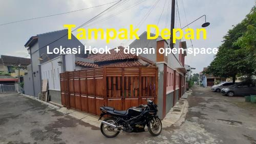 a motorcycle parked on a street next to a building at Homestay Cendana Candi 1 Kudus in Kudus