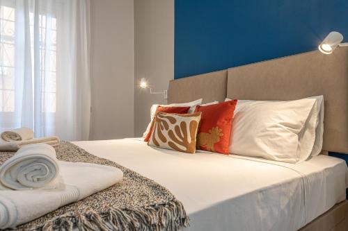 a bedroom with a large bed with pillows at Casa Abeba a Torre Maura in Rome