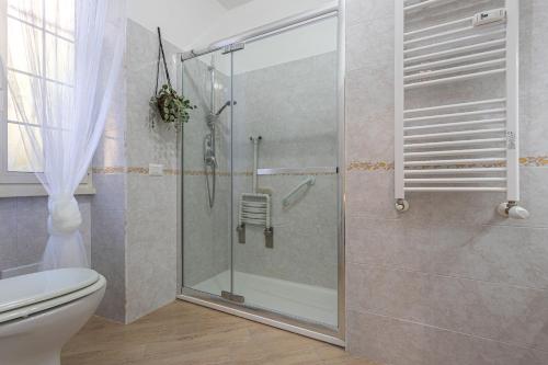 a bathroom with a shower with a glass door at Casa Abeba a Torre Maura in Rome