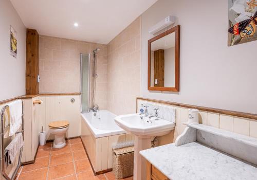 a bathroom with a sink and a toilet at 5 Swallowsholm Cottage in Richmond