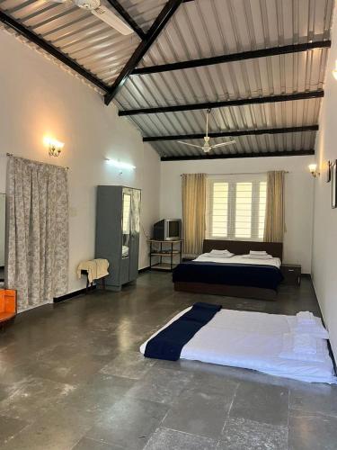 a bedroom with a large bed in a room at Mhaske Farms in Pune