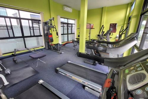 a gym with treadmills and machines in a room at Simple & Cozy Home in prime location. Chiang Mai in Chiang Mai