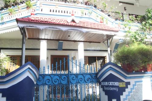 a blue and white house with a blue fence at DreamCatcher Residency in Cochin