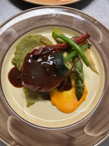 a plate of food with meat and vegetables on it at De Stobbe hotel & suites in Ruinen
