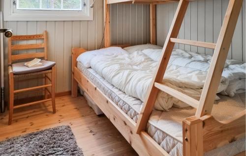 a bedroom with a bunk bed and a chair at Nice Home In Fossdal With House A Panoramic View in Fossdal