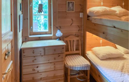 a tiny house with a bunk bed and a chair at Amazing Home In Fllinge With Wifi in Vallrun