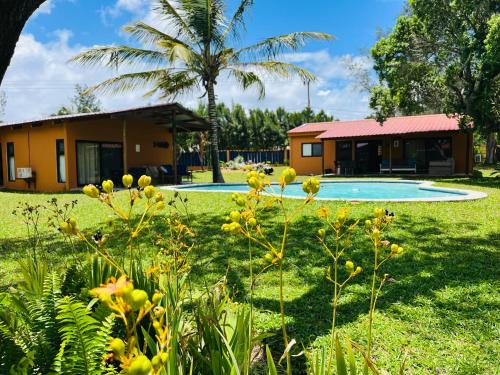 a house and a yard with a swimming pool at Twin House #2 in Ponta do Ouro