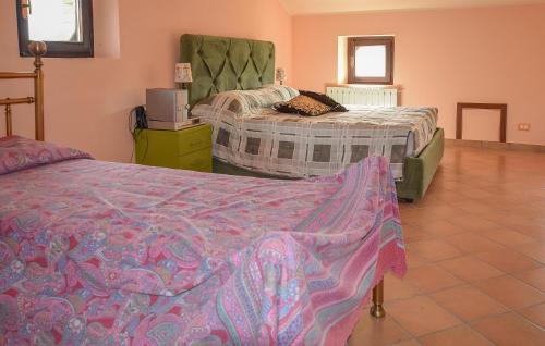 a bedroom with two beds and a tiled floor at Nice Home In Bellante With Kitchen in Bellante