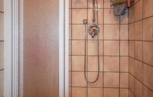 a shower with a shower head in a bathroom at Nice Home In Bellante With Kitchen in Bellante