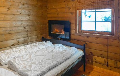 a bedroom with a bed in a room with a fireplace at Lovely Home In Stranda With Wifi in Stranda