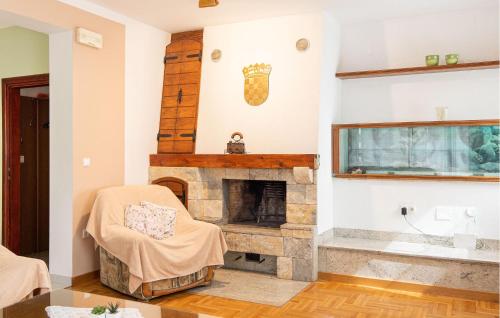 a living room with a stone fireplace at Lovely Home In Trilj With Heated Swimming Pool in Trilj