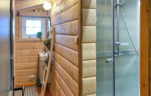a shower in a bathroom with wooden walls at Lovely Home In Stranda With Wifi in Stranda