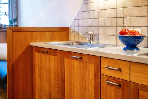 a kitchen with a sink and a bowl of fruit at Lechnerhof Apt 1 in Braies